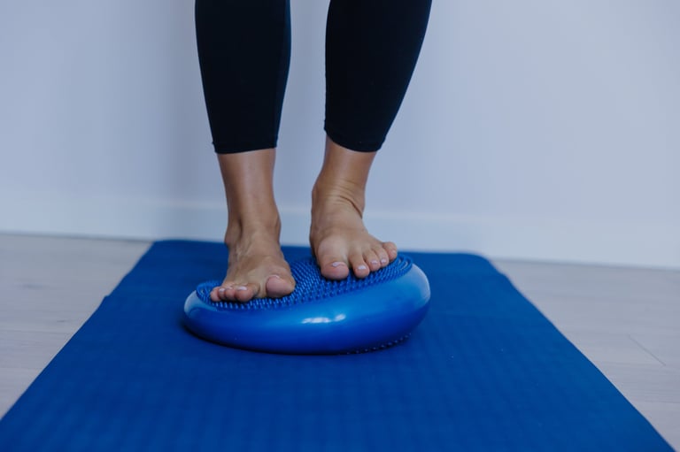 toes gripping wobble cushion while shifting weight forward, dynamic balance progression for toe strength